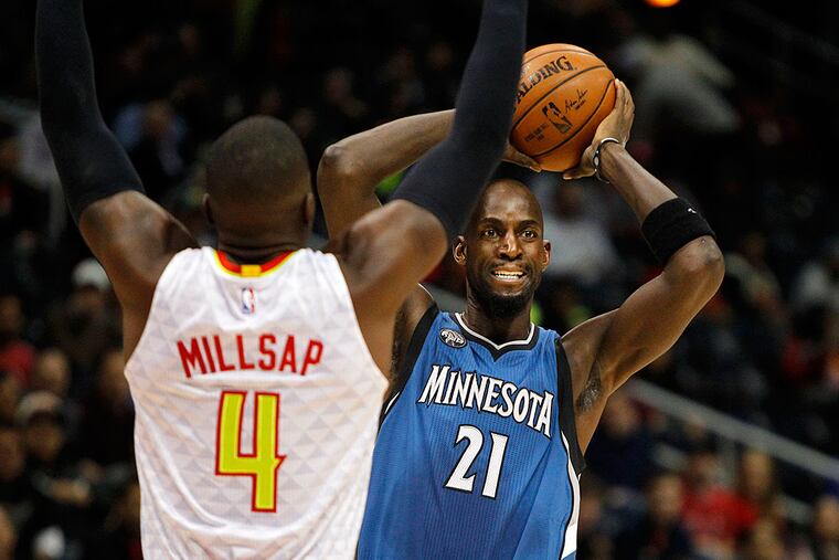 Minnesota Timberwolves forward Kevin Garnett (21) is defended by Atlanta Hawks forward Paul Millsap (4) in the first quarter at Philips Arena.