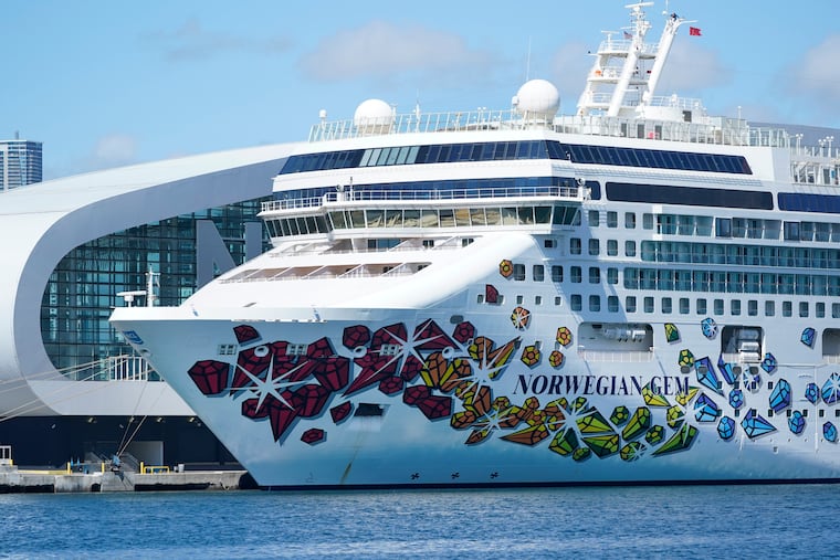 The Norwegian Gem cruise ship is shown docked in Miami. A federal judge has temporarily blocked a Florida law that prevents cruise lines from requiring passengers to prove they're vaccinated against COVID-19.