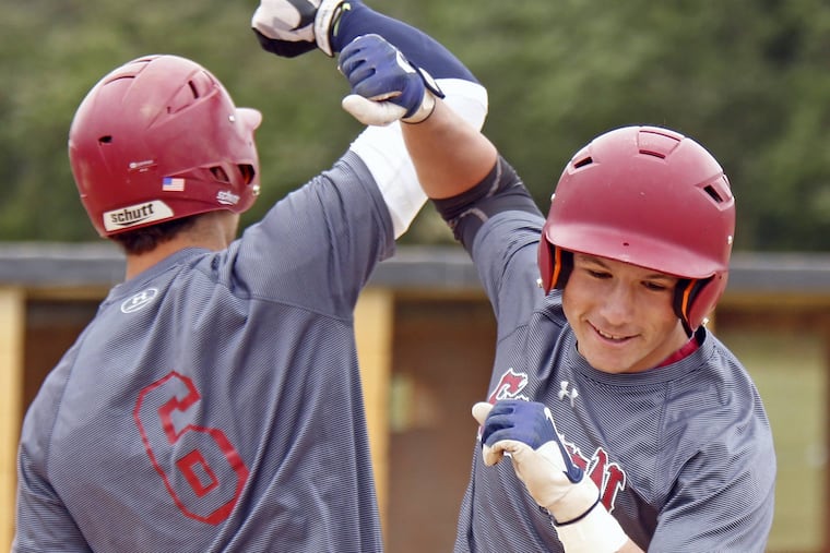 Eastern's Davis Schneider bumps forearms with teammate Jack Herman (6) after crushing a monster home run against Bishop Eustace in the third inning of a Diamond Classic baseball game Saturday, May 20, 2017 at Deptford. Eastern went on to win, 6-2.