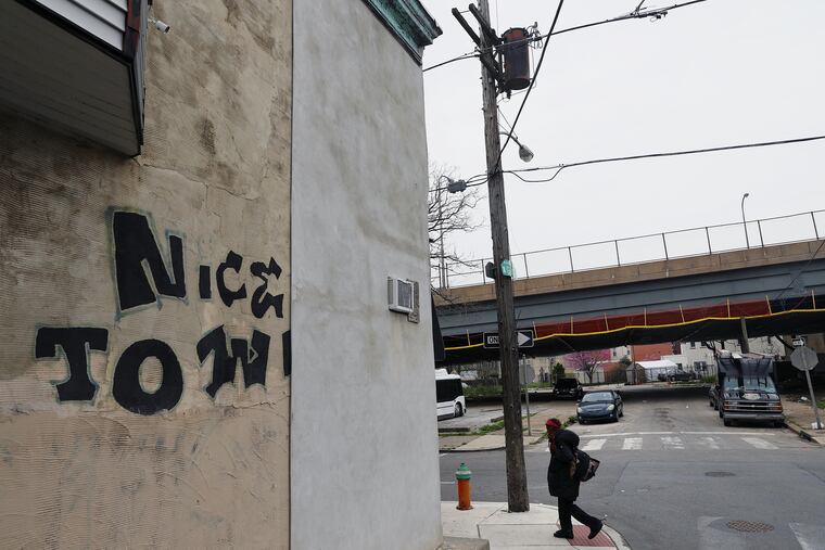 A pedestrian walks past Gratz Street in Nicetown in April.