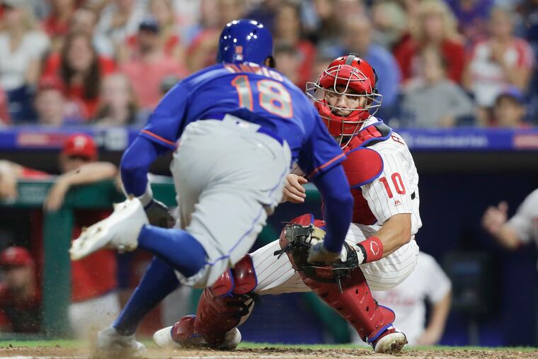 Phillies catcher J.T. Realmuto waits to tagout New York Mets center fielder Rajai Davis at home plate during the eighth-inning on Sunday, September 1, 2019 in Philadelphia.