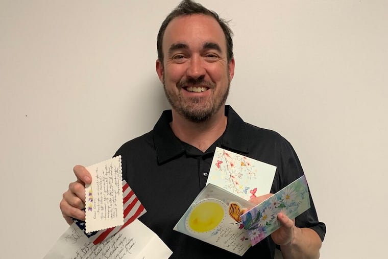 Jeff Lillie, mayor of Earlham, Iowa, with thank you notes sent to city hall after an anonymous donor's $82,000 gift.