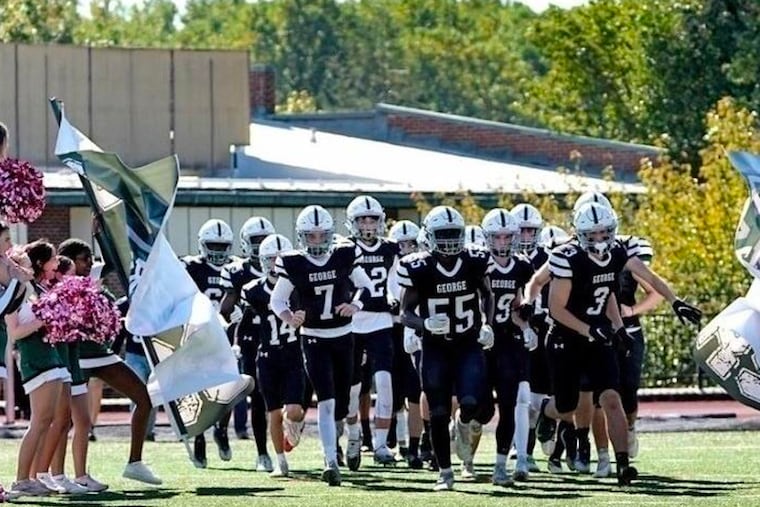 George School varsity football team running onto the field during the school's homecoming game.