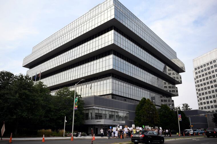 In this August 2018 file photo, family and friends who have lost loved ones to OxyContin and opioid overdoses protest outside Purdue Pharma headquarters in Stamford, Conn.