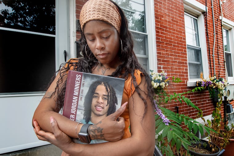 Rebecca Minners holds a photo of her late son Kristopher, at her home in Wilmington on July 26, 2022. Kristopher was killed in last month's mass shooting on South Street. Even as she grieves for her son, she's trying to keep his memory alive.