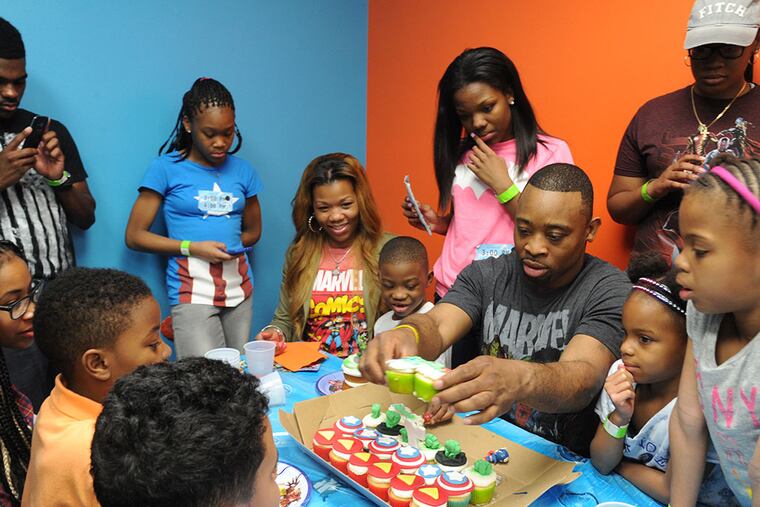 Fidel Napier and son Fidel Jr. at the son's birthday party, joined by family. (CLEM MURRAY / File Photograph)