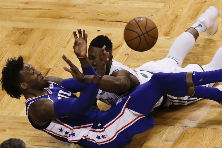 Sixers forward Robert Covington passes the ball after scrambling for the ball against Celtics guard Terry Rozier during the Sixers’ Game 5 loss to the Celtics.
