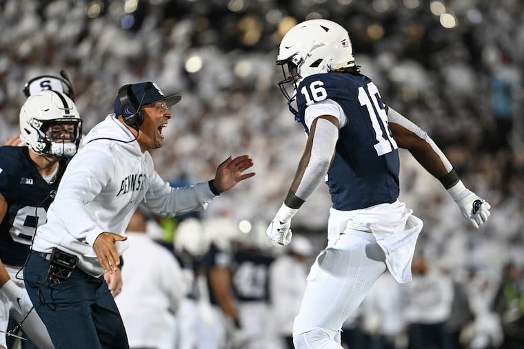 Penn State head coach James Franklin, left, celebrates with tight end Khalil Dinkins (16) after his touchdown against Iowa. This week, the Nittany Lions are looking to put forth the same energy against Iowa.
