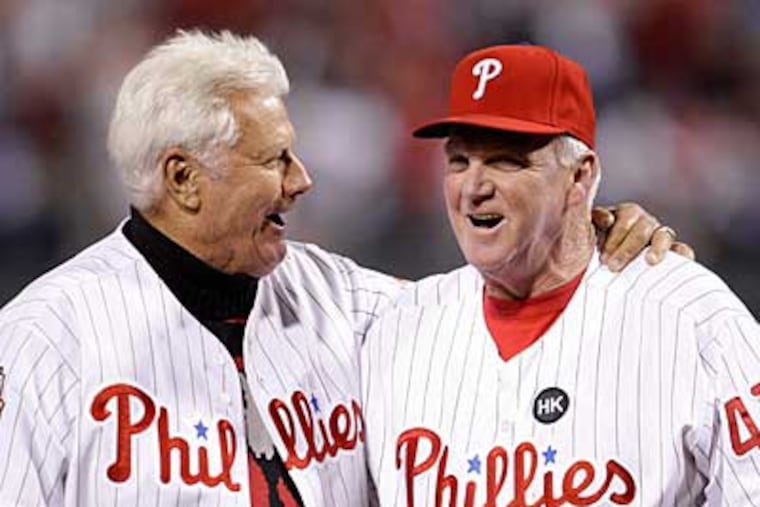 Former Phillies manager Dallas Green, left, hugs Charlie Manuel after Green threw out the first pitch before Game 5 of the NLCS. (AP Photo / Matt Slocum)