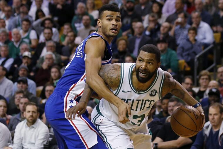 Boston's Marcus Morris struggles to get past Timothe Luwawu-Cabarrot of the Sixers.