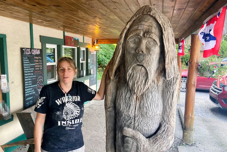 Pauline Bauer leans against a wooden statue outside Bob's Trading Post, her restaurant in Hamilton, Pa. Bauer, who screamed death threats directed at then-House Speaker Nancy Pelosi while storming the U.S. Capitol on Jan. 6, 2021, was sentenced on Tuesday to two years and three months in prison.