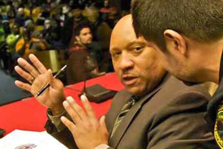 Coatesville City Manager Harry Walker prepares to address a community meeting of about 500 residents who turned out last night to discuss a wave of deliberately set fires that has terrorized the city since last year.