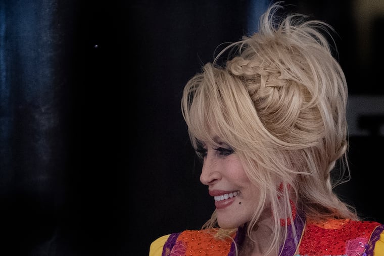 Dolly Parton shares a laugh on May 5, 2022, at the Wilmington Public Library in Wilmington. Parton joined Delaware Gov. John Carney to promote her Imagination Library, a program that gives books to children.