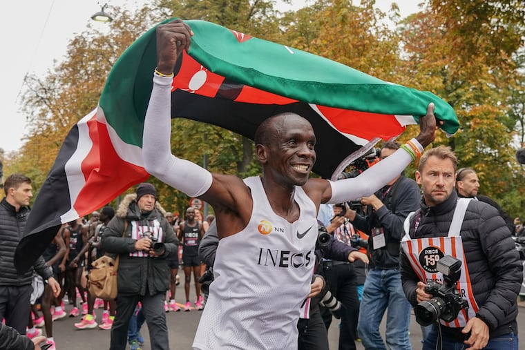 Eliud Kipchoge celebrates with the Kenyan flag after breaking the historic two hour barrier for a marathon in Vienna, Saturday, Oct. 12, 2019. Eliud Kipchoge has become the first athlete to run a marathon in less than two hours, although it will not count as a world record. The Olympic champion and world record holder from Kenya clocked 1 hour, 59 minutes and 40 seconds Saturday at the INEOS 1:59 Challenge, an event set up for the attempt.