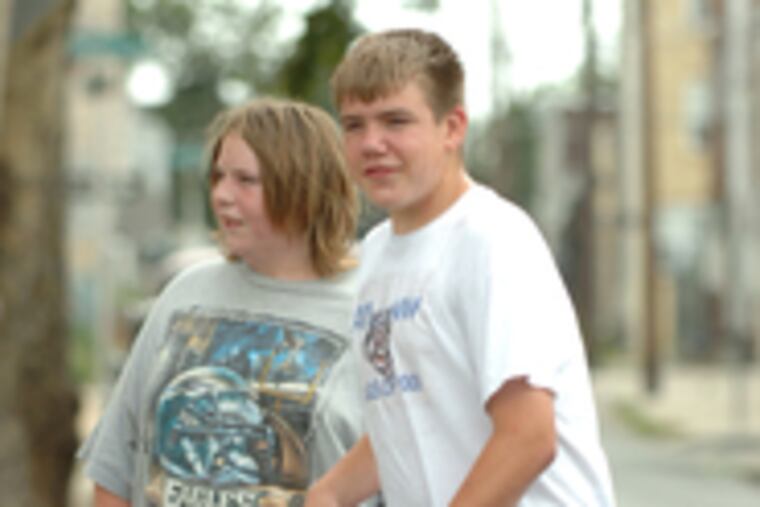 Watching construction are skateboarders Raymond Fredericksen (left), 16, and Michael Greenman, 14.