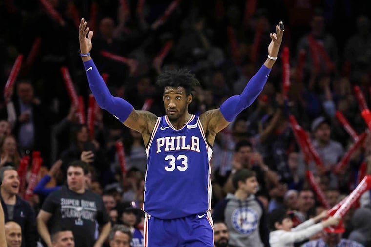 Robert Covington gets the fans involved against the Nuggets in March 2018.