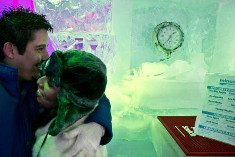 Eduardo Hernandez, left, and Ana Simon, embrace during a visit to the Minus 5 ice bar, on Monday, July 8, 2013 in New York. The city’s first ice bar is now open at the Hilton Hotel on Sixth Avenue. Admission includes Eskimo-style gloves, parkas and boots for the privilege of drinking cocktails in the freezing Minus 5 Ice Bar. (AP Photo/Bebeto Matthews)