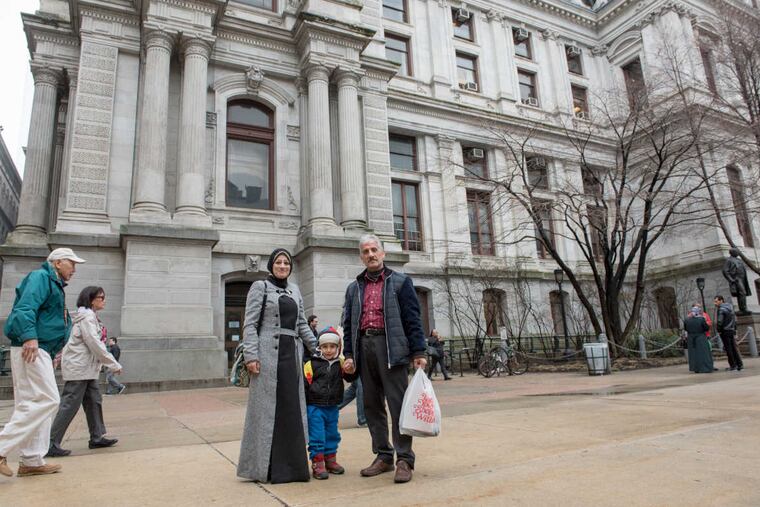 Ghufran Smakiaa, left, with Ahmad Kalajai and son, Laith, 3. Councilman David Oh hosted a welcoming reception for newly-arrived refugees from Syria and other countries in the Middle East in the City Hall Conversation Room on Monday Morning, March 27, 2017.