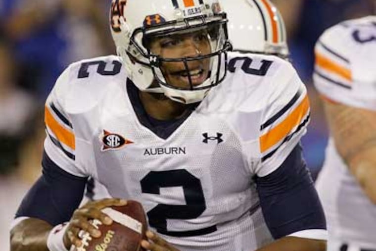 Cam Newton is a favorite to win this year's coveted trophy. (AP Photo/Ed Reinke, File)