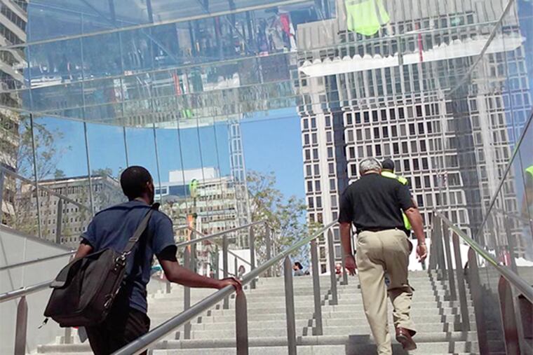 Pedestrians walk up the steps and into the new Dilworth Park on September 4, 2014. (Jessica Griffin / Staff Photographer)