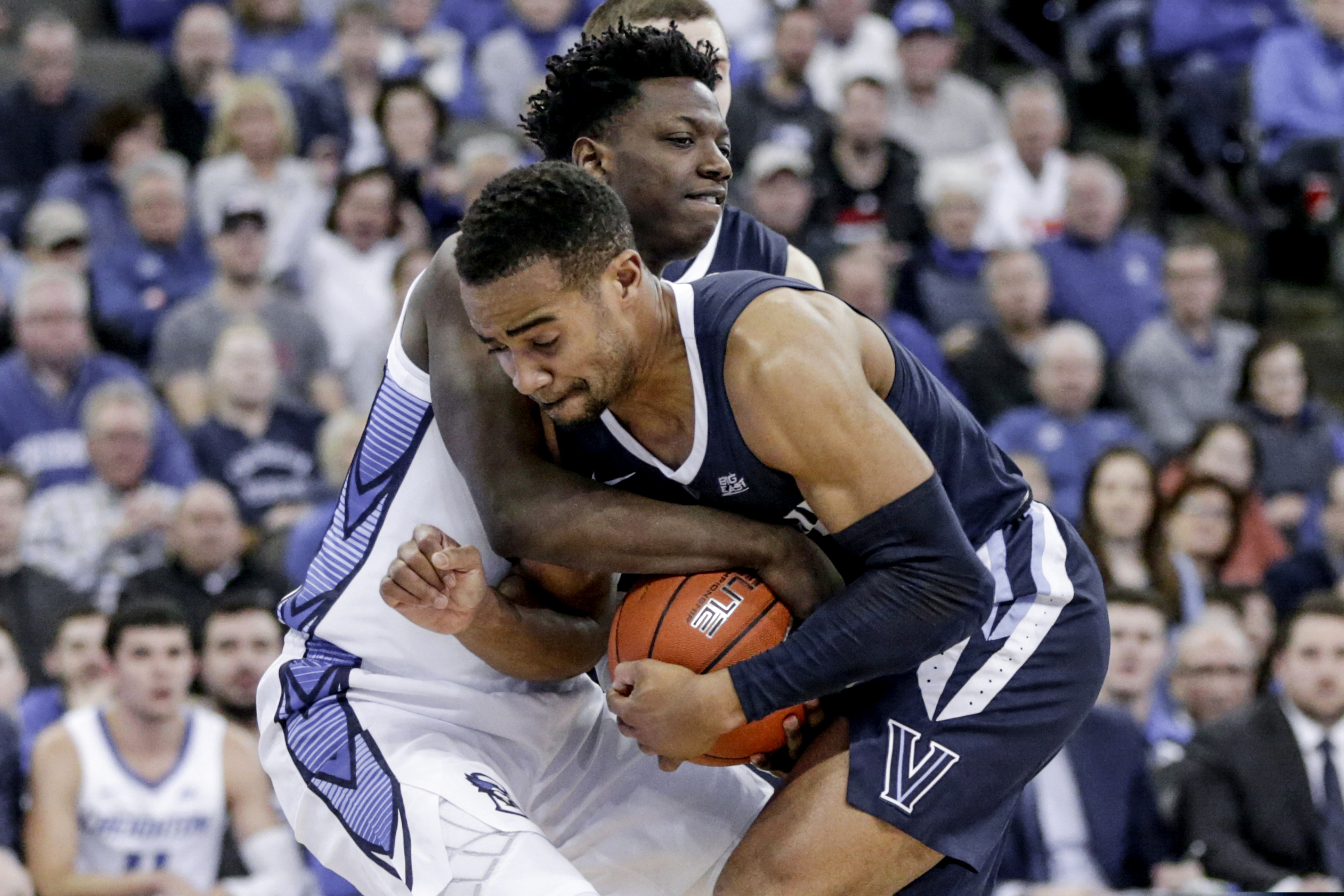 Villanova's Phil Booth and Creighton's Kaleb Joseph struggle for the ball during the second half of the Wildcats' 90-78 win on Sunday in Omaha, Neb.