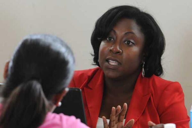Amber Racine, 32, president of the Barristers Association of Philadelphia, explains procedures in getting a criminal record expunged to a person who attended an expungement expo at Francis Myers Rec Center in SW Philadelphia July 19, 2014. ( CLEM MURRAY / Staff Photographer )
