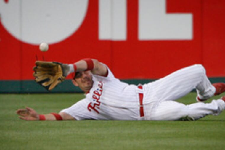 Phillies centerfielder Aaron Rowand can't get a ball hit by Washington's Austin Kearns in the second inning of last night's game. Kearns made it to third base.