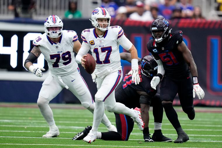 Buffalo Bills quarterback Josh Allen scrambles as Houston Texans defensive end Will Anderson pursues him during the second half Sunday.