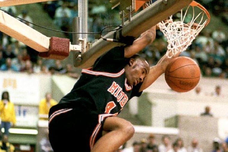 3/13/94 Hillside vs. Middle Twp. H.S.
boys basketball at Rutgers Athletic Center. Middle Twp's LaMarr Greer
hangs on the rim after scoring two points on a breakaway 3/13/94 .
(ELIZABETH VORHAUER)