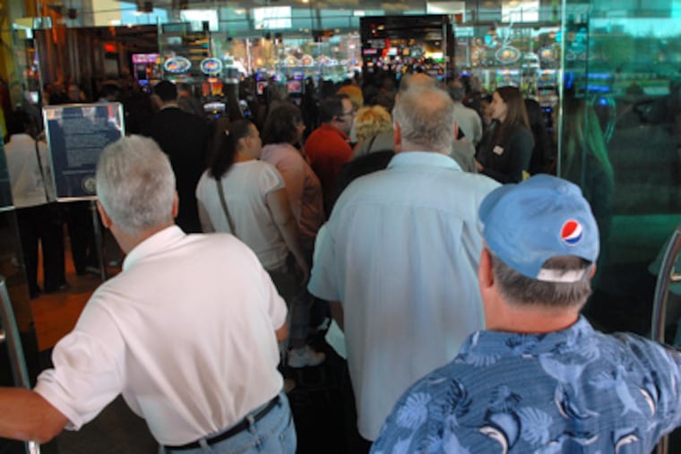 Gamblers pour into SugarHouse Casino as the doors open for the first of two test days. The hall will officially open Thursday. (Tom Gralish / Staff Photographer)