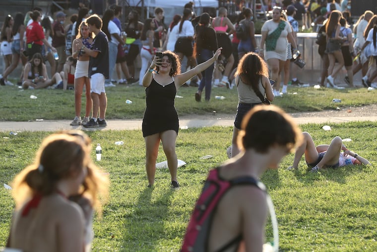 People dance from afar as Young Thug performs on the first day of the Made in America festival in 2021.