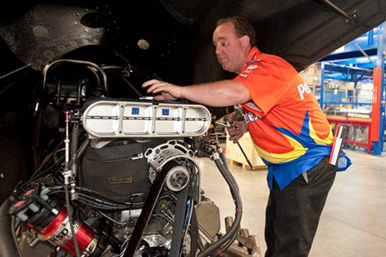 Jay Blake demonstrates how he works on his car at the Universal Technical Institute campus in Exton, where he will gave a talk to students. ( RON TARVER / Staff Photographer )