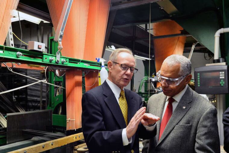 Near a shuttle loom, Bally Ribbon Mills chief Ray Harries (left) talks with NASA Administrator Charles Bolden. The firm is weaving NASA a thermal pad from quartz fiber.