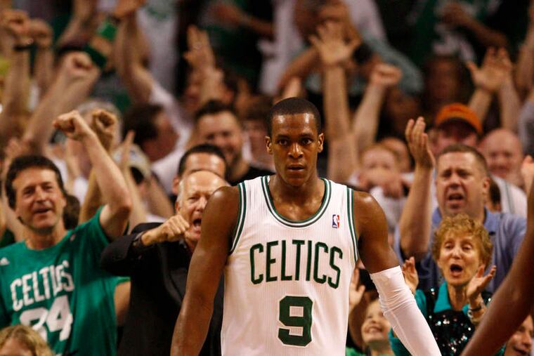 Agony and ecstasy in Game 7: Above, the Sixers' Lou Williams (left) and Jrue Holiday are glum after a Celtics basket put Boston ahead in the second quarter. Below, guard Rajon Rondo brings Celtics fans to their feet after a basket.