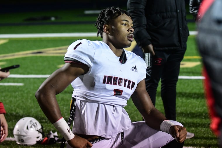 Imhotep Charter's linebacker Keon Wylie (1) gathers with his teammates at the conclusion of a PIAA 5A quarterfinal football game against Cathedral Prep in Bellefonte, Pa. on Saturday, Nov. 27, 2021. Wylie has committed to Penn State.