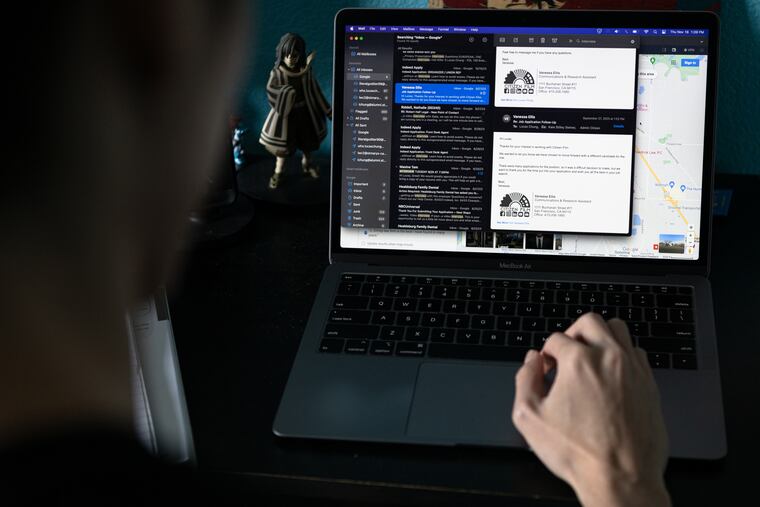 A job applicant opens a rejection letter from a prospective employer.