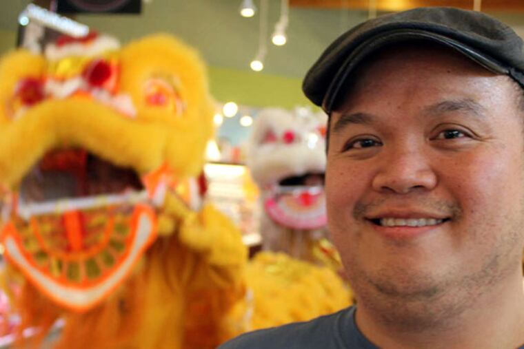 Jimmy Lee, at the opening festivities for his stand, Aziatisch, at the Ardmore Farmers Market on Feb. 1, 2014. ( MICHAEL KLEIN / Philly.com )