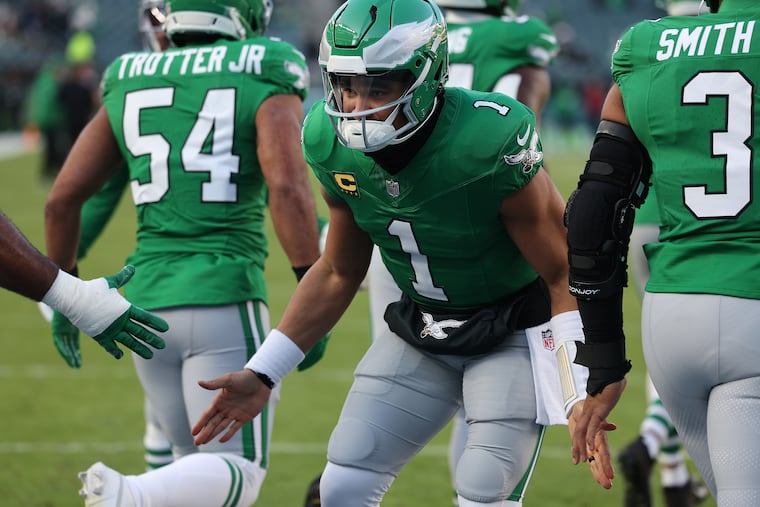 Eagles quarterback Jalen Hurts greets his teammates before Sunday's regular-season finale against Washington.