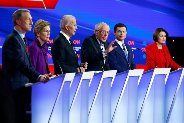Democratic presidential candidate Sen. Bernie Sanders, I-Vt.,, center, speaks as fellow candidates businessman Tom Steyer, from left, Sen. Elizabeth Warren, D-Mass., former Vice President Joe Biden, former South Bend Mayor Pete Buttigieg and Sen. Amy Klobuchar, D-Minn. listen, Tuesday, Jan. 14, 2020, during a Democratic presidential primary debate hosted by CNN and the Des Moines Register in Des Moines, Iowa.