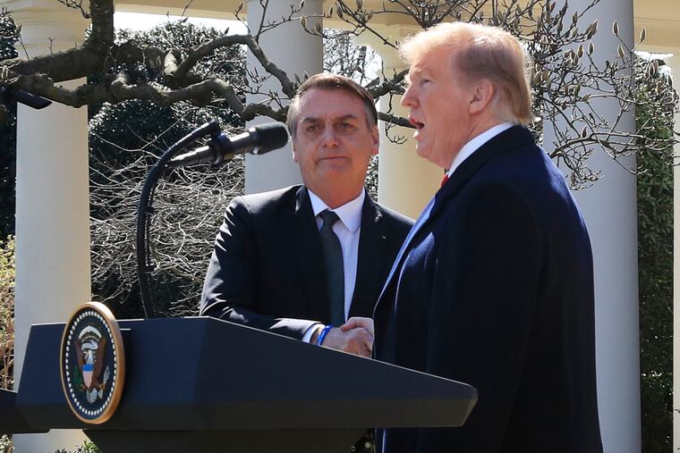 President Donald Trump and visiting Brazilian President Jair Bolsonaro shake hands as they conclude a news conference on the Rose Garden of the White House, Tuesday, March 19, 2019, in Washington. (AP Photo/Manuel Balce Ceneta)
