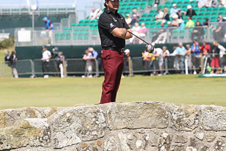 Graeme McDowell poses for a picture on the Swilcan Bridge at St. Andrews. (Peter Morrison/AP file photo)