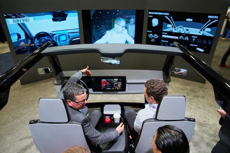 People experience a Gentex driver and in-camera monitoring system exhibit during the CES tech show Tuesday, Jan. 6, 2026, in Las Vegas.