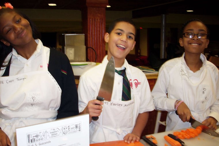 Tashya Anderson (from left), Xavier Melendez, and Jordan McKinney slice vegetables for the chili.