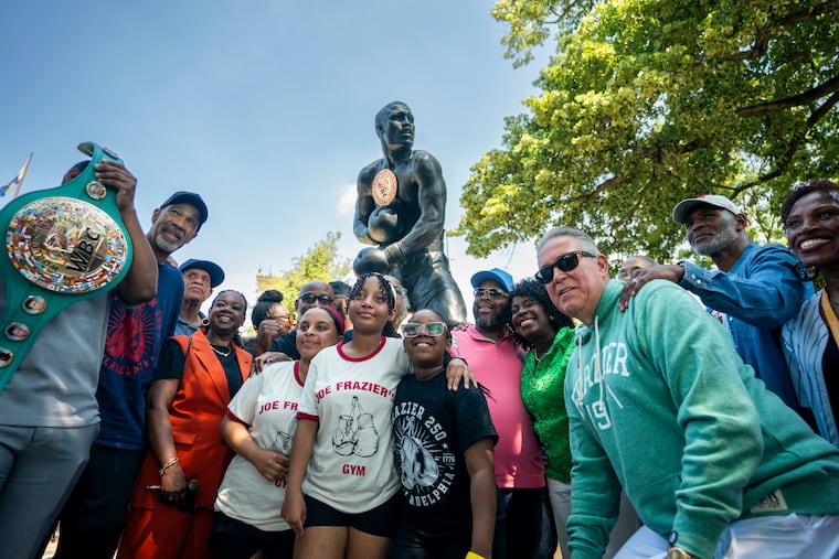 Mayor Cherelle L. Parker with Frazier family members, boxers, and other dignitaries unveil the new home for its statue of heavyweight boxing champion Joe Frazier on Monday. The statue is installed at the base of the steps of the Philadelphia Museum of Art where a statue of fictional boxer Rocky Balboa once stood.