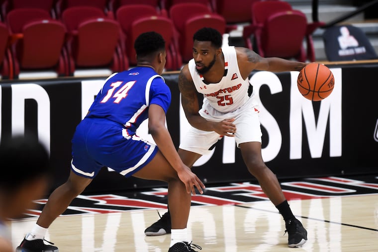 Hartford's Traci Carter (25) faces off against UML's Anthony Blunt (14) as the University of Hartford Hawks go up against the UMass Lowell River Hawks for the America East Championship at Reich Family Pavilion Saturday, March 13, 2021, at University of Hartford. Hartford won 64-50, clenching their first NCAA Tournament berth.
