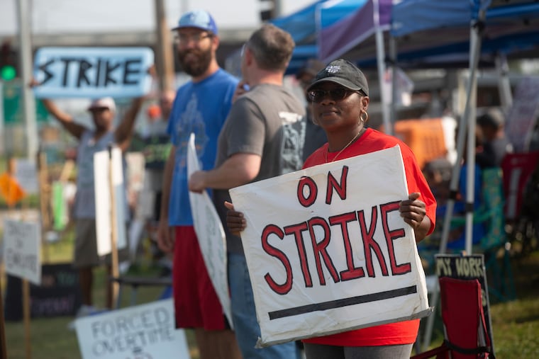 Kym Lewis, a Frito-Lay employee, stands on the strike line Thursday, July 22, 2021 outside of the Topeka plant. Workers said the main points of contention are small pay increases and employees being forced to work hours of overtime.