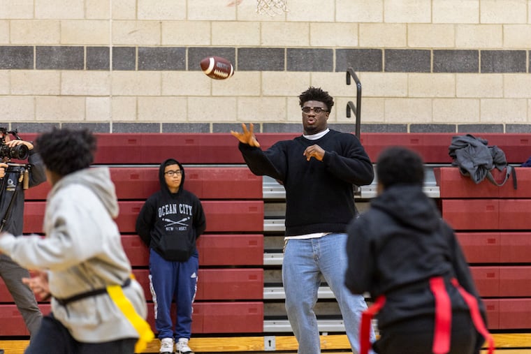 Jordan Davis played flag football with kids at the Salvation Army Camden Kroc Center on Tuesday.