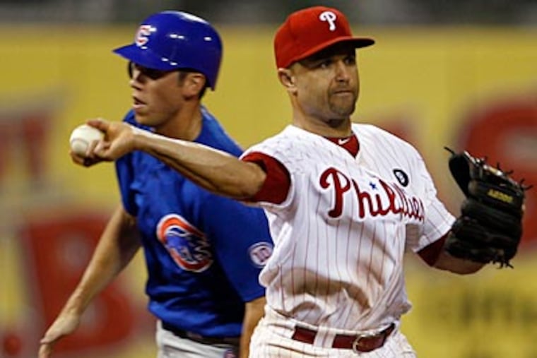 Placido Polanco's throwing error in the 11th inning allowed the Cubs to score. (Yong Kim/Staff Photographer)