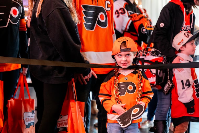 Archie Smigelski, 5, waits in line with other fans for an autograph. His parents, Alex and Jill, traveled from Buffalo, NY to attend their third carnival.