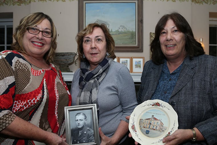 Lorie Jaworski, left, Fran Peltier, center, and, Dorothy Jaworski, right, pose with a photo of Stephen Jaworski, who was honored for his service in World War II. (Andrew Thayer / Staff Photographer)